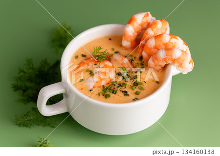 Fresh seafood soup highlighting vibrant shrimp and smooth creamy broth Fresh seafood soup highlighting vibrant shrimp and smooth creamy broth 134160138