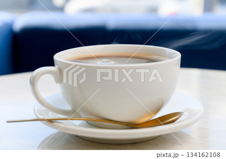 Aromatic strong Americano or espresso in a white cup with foam Aromatic strong Americano or espresso in a white cup with foam 134162108