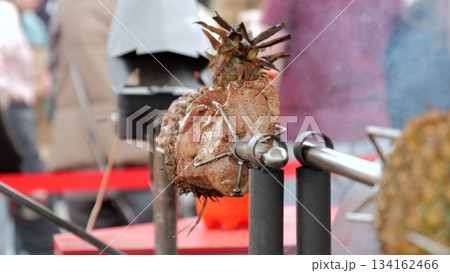 Charcoalgrilled pork with pineapple, Barbecued pork and pineapple skewers on smoky charcoal grill, Vendor preparing grilled pork skewers with pineapple slices over wood charcoal fire for customers Charcoalgrilled pork with pineapple, Barbecued pork and pineapple skewers on smoky charcoal grill, Vendor preparing grilled pork skewers with pineapple slices over wood charcoal fire for customers 134162466