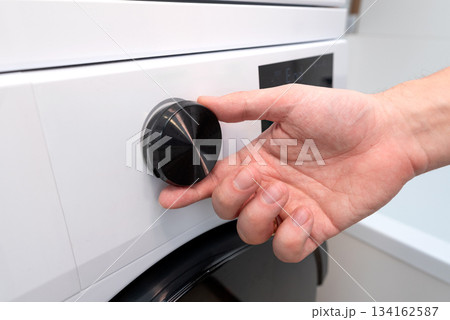 White washing machine in a utility room White washing machine in a utility room 134162587