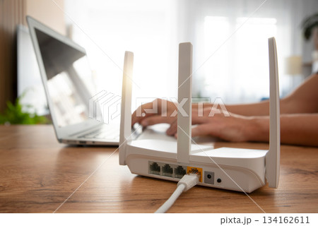 Modern wi-fi router on light table in room Modern wi-fi router on light table in room 134162611