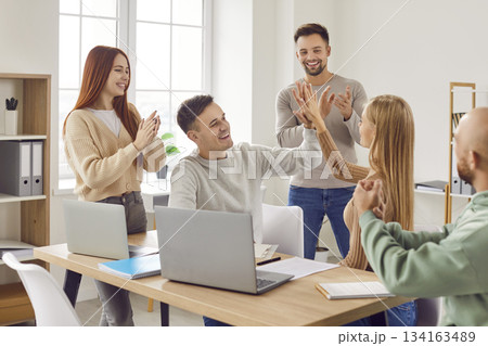 Team of happy, joyful people having fun and celebrating making successful deal together Team of happy, joyful people having fun and celebrating making successful deal together 134163489