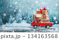 Festive christmas truck carrying gifts in snowy winter wonderland scene. Horizontal banner. Copy space. Free space for text 134163568