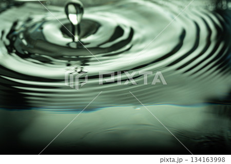 242.Green-Tinted Ripples and Droplet on Water Surface 134163998