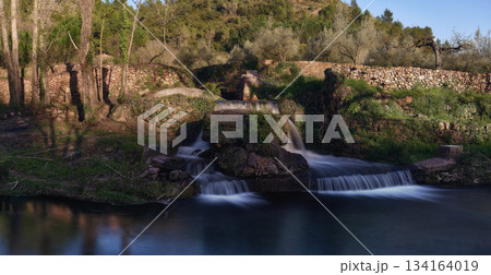 Small waterfalls in a mountain stream on a sunny day 134164019