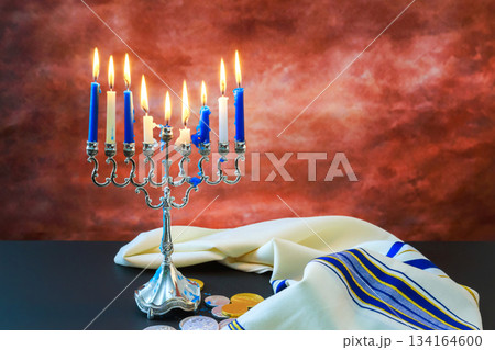 Celebration with menorah coins during Hanukkah at home setting in evening 134164600