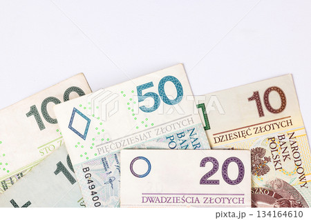 Collection of Polish banknotes of different denominations on a light background 134164610
