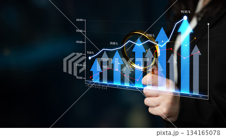 Business growth analysis with magnifying glass and digital graph illustration showing upward trends and success metrics on dark background Scalp 134165078