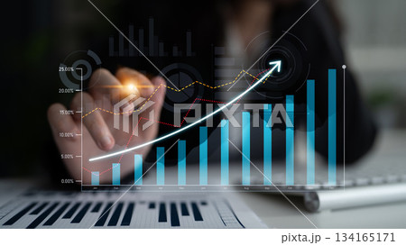 Business Person Analyzing Growth Chart with Projections in a Modern Office Environment, Focusing on Data Presentation and Analysis Techniques Scalp 134165171