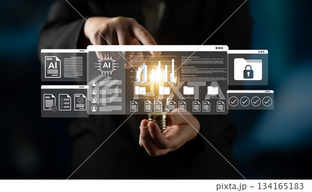 Hands holding lightbulb with digital interface showcasing artificial intelligence concepts, secure data, and innovative technology solutions in a modern setting Gantry 134165183
