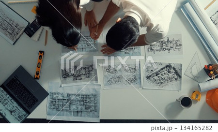 Top view of architect engineer place document at meeting table. Alimentation. Top view of architect engineer place document at meeting table. Alimentation. 134165282