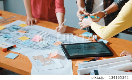 Close up of architect hand pointing at blueprint on meeting table. Symposium. 134165342