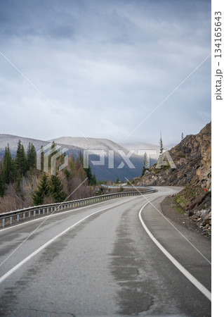 Mountain road and valley of Chuysky Trakt Altai Russia. Scenic route through rugged terrain and expansive natural landscape 134165643