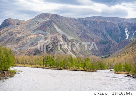 Wide Chulyshman riverbed near Katu Yaryk pass in Altai mountains Russia Powerful mountain waterway flowing through open valley Wide Chulyshman riverbed near Katu Yaryk pass in Altai mountains Russia Powerful mountain waterway flowing through open valley 134165645