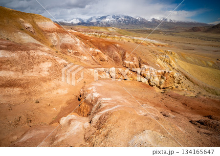 Panoramic view of red and yellow mountains with canyons and gorges at Mars Altai Russia. Popular tourist destination showcasing unique colorful geological formations. Panoramic view of red and yellow mountains with canyons and gorges at Mars Altai Russia. Popular tourist destination showcasing unique colorful geological formations. 134165647