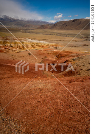 Panoramic view of red and yellow mountains with canyons and gorges at Mars Altai Russia. Popular tourist destination showcasing unique colorful geological formations. 134165651