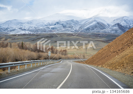 Mountain road and valley of Chuysky Trakt Altai Russia. Scenic route through rugged terrain and expansive natural landscape 134165686