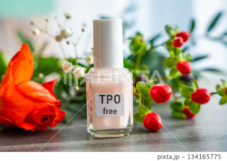 TPO free gel nail polish lying on a table in soft natural light. Highlighting clean beauty choices and awareness of Trimethylbenzoyl Diphenylphosphine Oxide in cosmetics 134165775