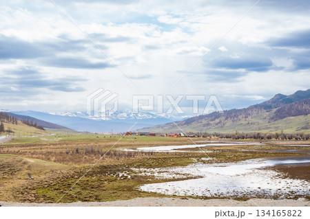 Mountain ridge valley and peaks in Ulagan region Altai Russia. Expansive alpine landscape with rugged terrain and natural wilderness Mountain ridge valley and peaks in Ulagan region Altai Russia. Expansive alpine landscape with rugged terrain and natural wilderness 134165822