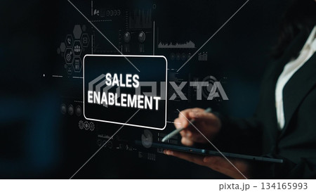 Professional Businesswoman Presenting Sales Enablement Strategy with Data Visualizations on Digital Screen. Asymptotic smart data analytic 134165993
