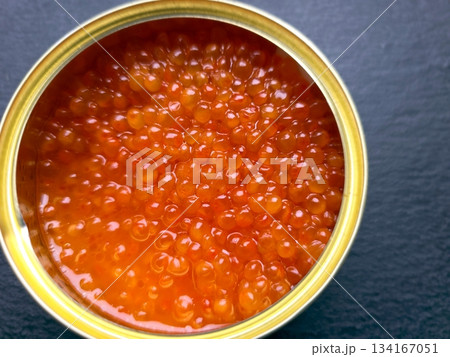 Red Salmon Caviar in a Jar on a Dark Background With Beads of Caviar Visible and Shiny 134167051