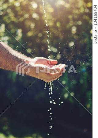 Water, wellness and hydration with a person washing hands outdoor in nature for life, sustainability or moisture. Environment, splash and wet with an adult cleaning outside for wellness or hygiene Water, wellness and hydration with a person washing hands outdoor in nature for life, sustainability or moisture. Environment, splash and wet with an adult cleaning outside for wellness or hygiene 134168434