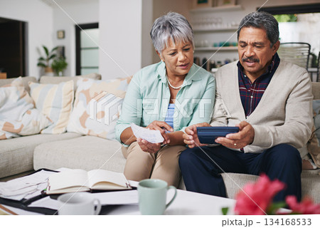 Elderly couple, financial debt and life insurance discussion with banking document and bills. Retirement fund, senior people and communication in a home living room with paperwork and contract 134168533