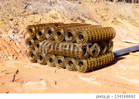 Construction site stores rolled wire mesh for upcoming building project Construction site stores rolled wire mesh for upcoming building project 134168692