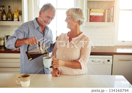 Happy, coffee or old couple talking in a kitchen at home bonding or enjoying quality morning time together. Love, wellness or mature man in conversation, relaxing or drinking espresso tea with woman Happy, coffee or old couple talking in a kitchen at home bonding or enjoying quality morning time together. Love, wellness or mature man in conversation, relaxing or drinking espresso tea with woman 134168794