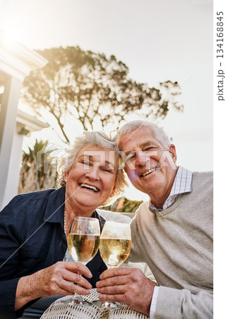 Love, cheers and wine, portrait old couple celebrate romantic anniversary date on patio of vacation home. Champagne, senior man and happy woman with toast, happiness and romance on holiday with smile 134168845