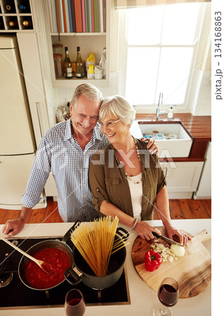 Affection, smile or happy old couple kitchen cooking with love or healthy food for dinner together at home. Embrace or above of senior woman helping or hugging an elderly husband in meal preparation Affection, smile or happy old couple kitchen cooking with love or healthy food for dinner together at home. Embrace or above of senior woman helping or hugging an elderly husband in meal preparation 134168863
