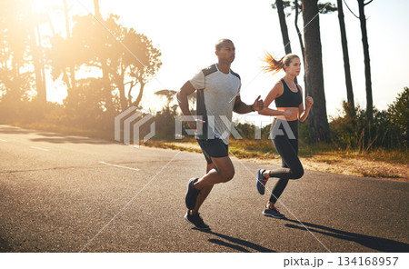 Fitness, running and freedom with couple in road for workout, cardio performance and summer. Marathon, exercise and teamwork with black man and woman runner in nature for sports, training and race 134168957