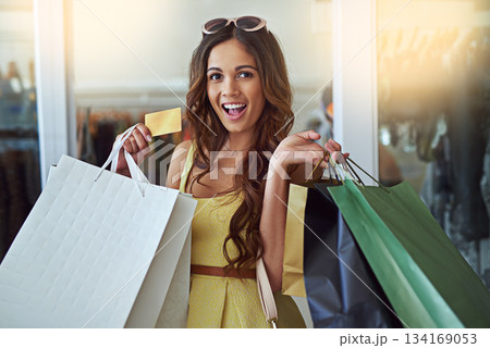 Woman, credit card and shopping bags portrait in store for fashion, sale or discount deal and fun. Female person or happy customer with retail bag to shop promotion offer or designer product at mall 134169053