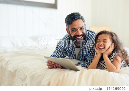 Bed, digital tablet and girl laughing with father, relax and sharing comic or joke in their home together. Happy, comedy and parent and with girl in bedroom online for funny meme or subscription Bed, digital tablet and girl laughing with father, relax and sharing comic or joke in their home together. Happy, comedy and parent and with girl in bedroom online for funny meme or subscription 134169092