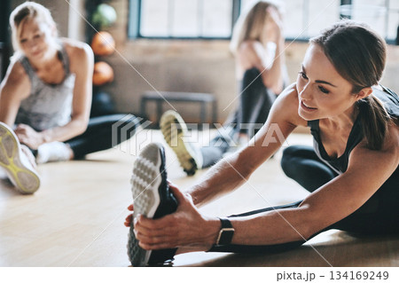 Gym, exercise and women stretching, workout and training for wellness, healthy lifestyle and balance. Female people, athletes or girls on the floor, practice and sports with progress, focus or energy Gym, exercise and women stretching, workout and training for wellness, healthy lifestyle and balance. Female people, athletes or girls on the floor, practice and sports with progress, focus or energy 134169249