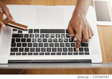 Woman, hands and credit card payment on laptop for online shopping, ecommerce or internet store. Above hands of a female entrepreneur typing at desk for business banking, booking or fintech website Woman, hands and credit card payment on laptop for online shopping, ecommerce or internet store. Above hands of a female entrepreneur typing at desk for business banking, booking or fintech website 134169387