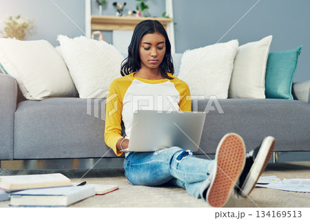Student laptop, home living room and woman reading, typing or work on research project, university report or studying. Serious focus, lounge floor and female person learning, education and search web 134169513