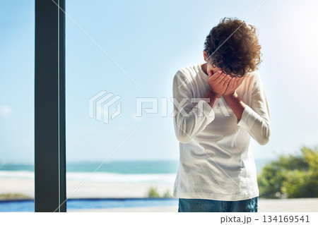 Sad, depression and crying child with hands covering face while lonely and unhappy. Depressed, psychology and scared boy kid with anxiety problem, grief or upset in isolation in a house Sad, depression and crying child with hands covering face while lonely and unhappy. Depressed, psychology and scared boy kid with anxiety problem, grief or upset in isolation in a house 134169541
