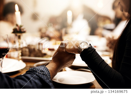 Prayer, food and hand holding with family at table in dining room for holiday, thanksgiving or worship. Celebration, support and gratitude with closeup of people at home for kindness, dinner and love Prayer, food and hand holding with family at table in dining room for holiday, thanksgiving or worship. Celebration, support and gratitude with closeup of people at home for kindness, dinner and love 134169675