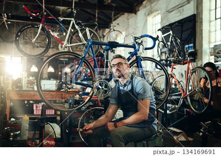 Portrait, tools and serious repair man in bicycle shop, store or cycling workshop. Face, bike mechanic and male person, business owner or mature professional technician with glasses and confidence. Portrait, tools and serious repair man in bicycle shop, store or cycling workshop. Face, bike mechanic and male person, business owner or mature professional technician with glasses and confidence. 134169691