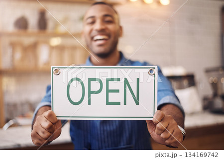 Open, sign and closeup of man in shop, store and advertising notice of retail shopping time, board or trading information. Hands of happy cafe owner with opening banner, welcome and startup services Open, sign and closeup of man in shop, store and advertising notice of retail shopping time, board or trading information. Hands of happy cafe owner with opening banner, welcome and startup services 134169742