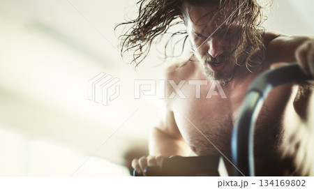 Fitness, workout and man on elliptical in gym for health, training and exercise. Sports, wellness and male athlete on cross trainer bike for exercising, cardio and cycling for strength and power. Fitness, workout and man on elliptical in gym for health, training and exercise. Sports, wellness and male athlete on cross trainer bike for exercising, cardio and cycling for strength and power. 134169802