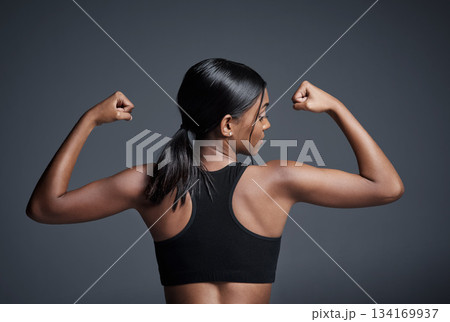 Sports, workout and woman flexing back in studio isolated on a black background. Strong flex, muscle and female athlete with bicep, arm strength or bodybuilder training, fitness and healthy exercise. Sports, workout and woman flexing back in studio isolated on a black background. Strong flex, muscle and female athlete with bicep, arm strength or bodybuilder training, fitness and healthy exercise. 134169937