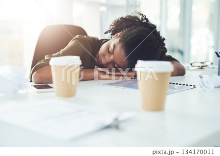 Tired, sleeping and business woman on desk with fatigue, stress and exhausted working in office. Burnout, overworked and lazy African female worker overwhelmed for deadline, workload and pressure 134170011