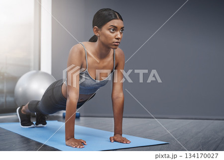 Stretching, training and woman in the gym for fitness, exercise or workout for commitment to health and wellness. Yoga, serious and healthy young female person ready morning sport performance Stretching, training and woman in the gym for fitness, exercise or workout for commitment to health and wellness. Yoga, serious and healthy young female person ready morning sport performance 134170027