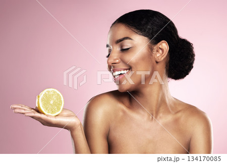 Lemon, healthy beauty and happy woman in studio mockup, pink background and smile for vitamin c benefits. African model, citrus fruits and natural skincare for cosmetics, vegan dermatology and detox 134170085
