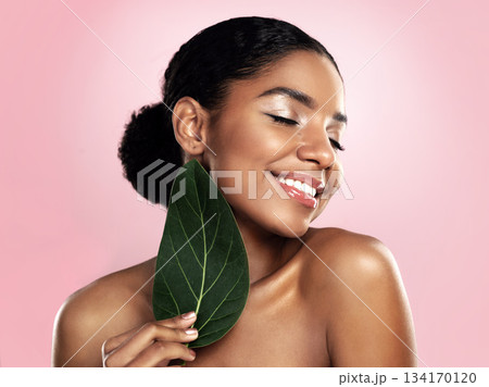Happy woman, green skincare and natural leaves in studio, pink background or eco friendly aesthetic cosmetics. Face, african model and beauty from plants, leaf and sustainability of vegan dermatology Happy woman, green skincare and natural leaves in studio, pink background or eco friendly aesthetic cosmetics. Face, african model and beauty from plants, leaf and sustainability of vegan dermatology 134170120
