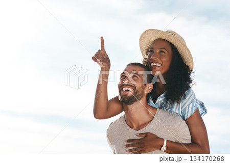 Sky, piggyback and happy couple pointing at space with nature on romantic summer holiday travel and mockup. Love, man and woman on adventure with happiness on date, romance and vacation together. 134170268