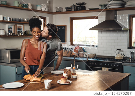 Interracial couple, kiss and cooking breakfast in kitchen for morning, love or care in marriage at home. Happy man kissing woman for food, nutrition or hug in happiness for healthy relationship Interracial couple, kiss and cooking breakfast in kitchen for morning, love or care in marriage at home. Happy man kissing woman for food, nutrition or hug in happiness for healthy relationship 134170297