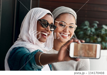 Selfie, muslim people and friends with sunglasses in city for social media, influencer content creation or fashion blog. Happy gen z women in Saudi Arabia, emoji profile picture or online photography 134170408